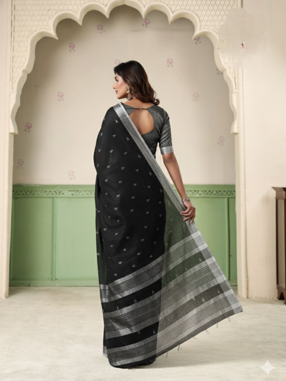 Full length view of black linen silk saree with thread woven butti design showcasing graceful drape
