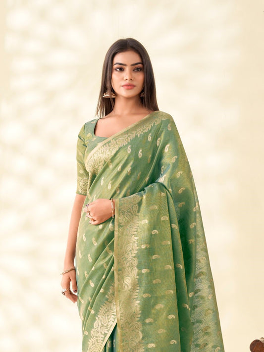 Model posing in green tissue linen silk saree with zari butti and pallu showcasing full length elegant styling