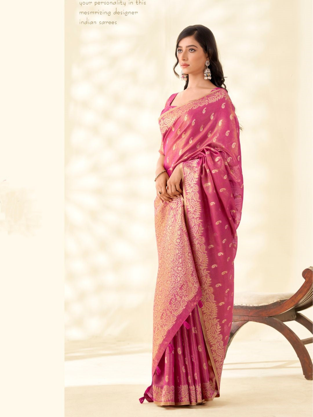 Model posing in pink tissue linen silk saree with zari weaving butti and pallu showing full length elegant styling