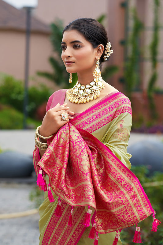 Pista green Banarasi silk saree with zari woven pallu and contrast border drape