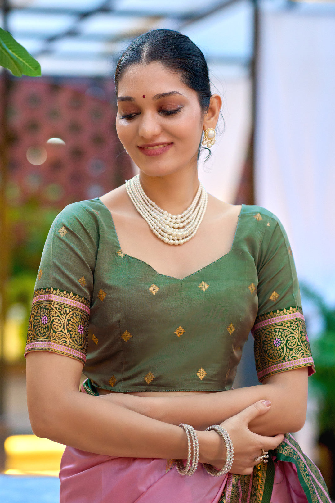 Closeup look of baby pink Banarasi silk saree blouse with zari weaving work