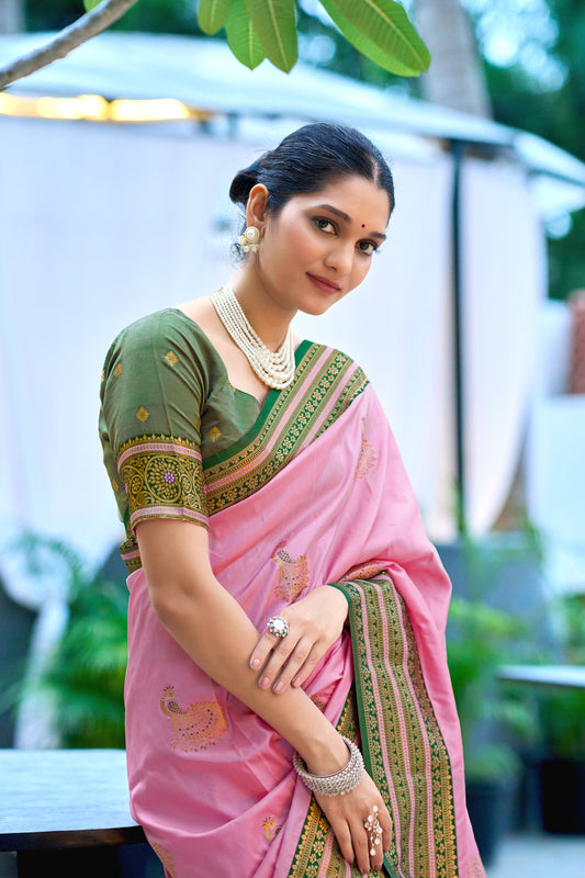 Model wearing baby pink Banarasi silk saree with zari weaving and contrast border