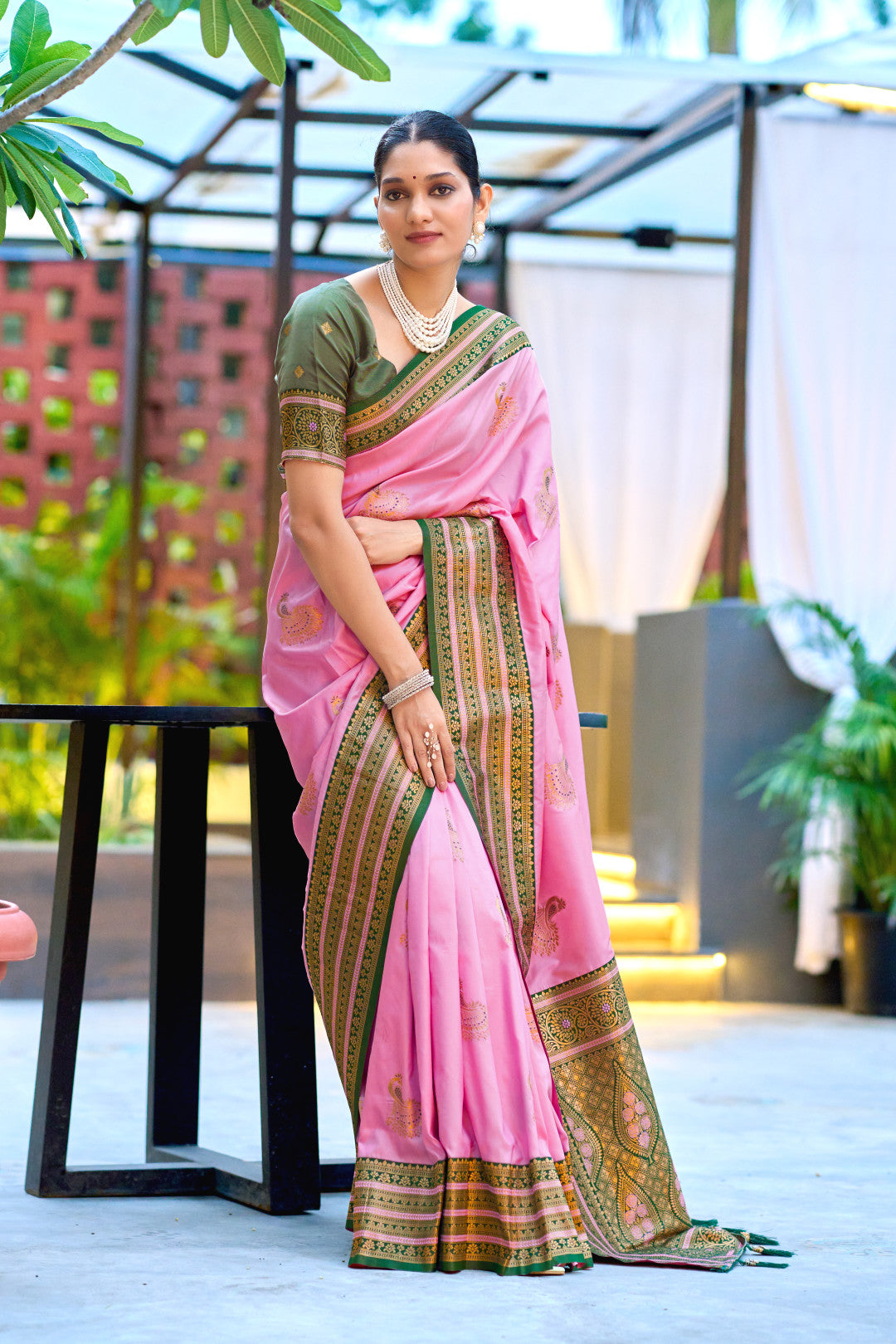 Baby pink Banarasi silk saree with contrast zari border in flowing drape look