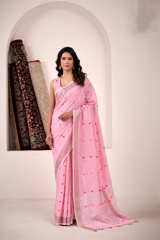 Woman wearing baby pink soft linen silk saree with zari weaving and elegant pallu full view