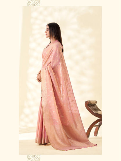 Model posing in baby pink tissue linen silk saree with zari butti and pallu showing full length elegant styling