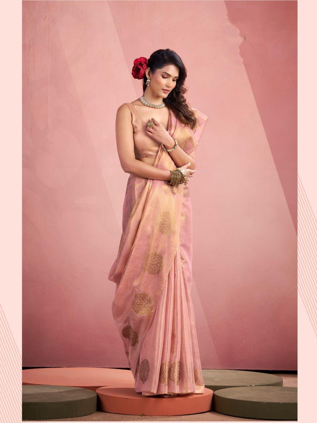 Model posing in baby pink tissue silk saree with zari butta showing full length party and wedding wear styling