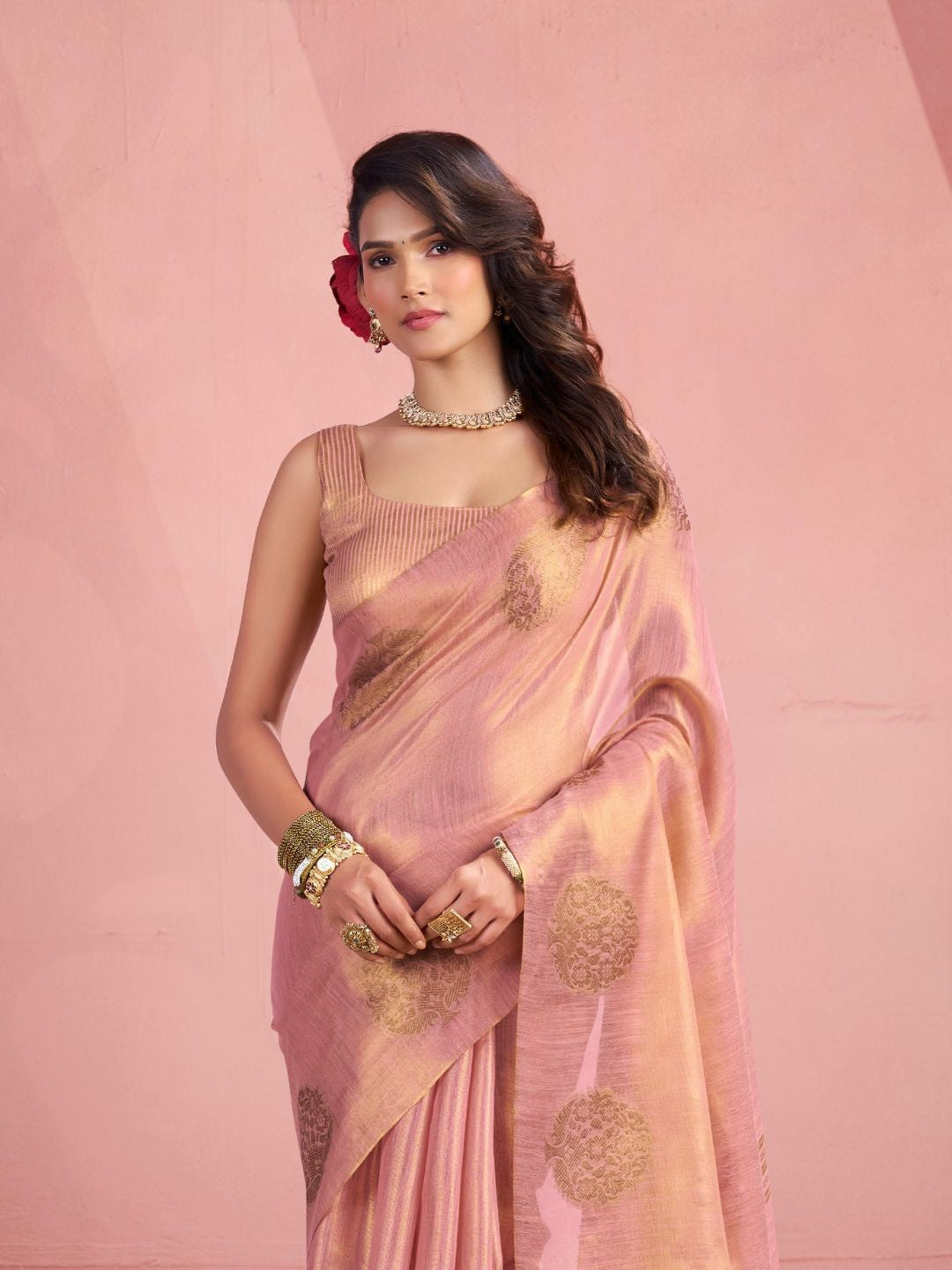 Side portrait of baby pink tissue silk saree with fancy zari weaving butta highlighting graceful drape