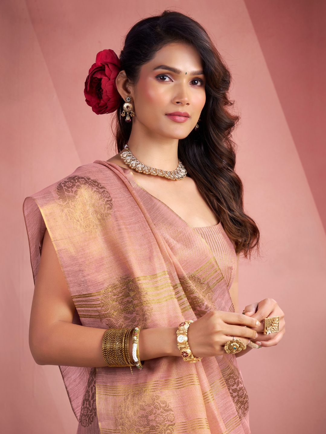 Close view of baby pink tissue silk saree with fancy zari butta showcasing elegant drape and detailing