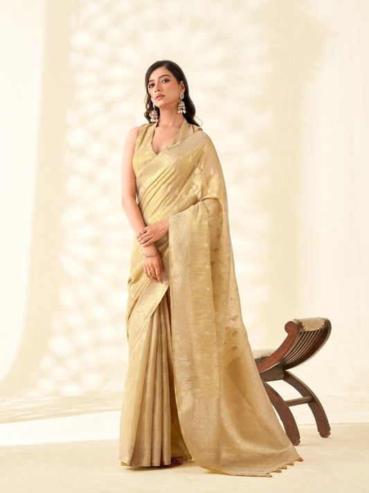 Woman wearing beige tissue linen silk saree with zari weaving butti and rich pallu full front view