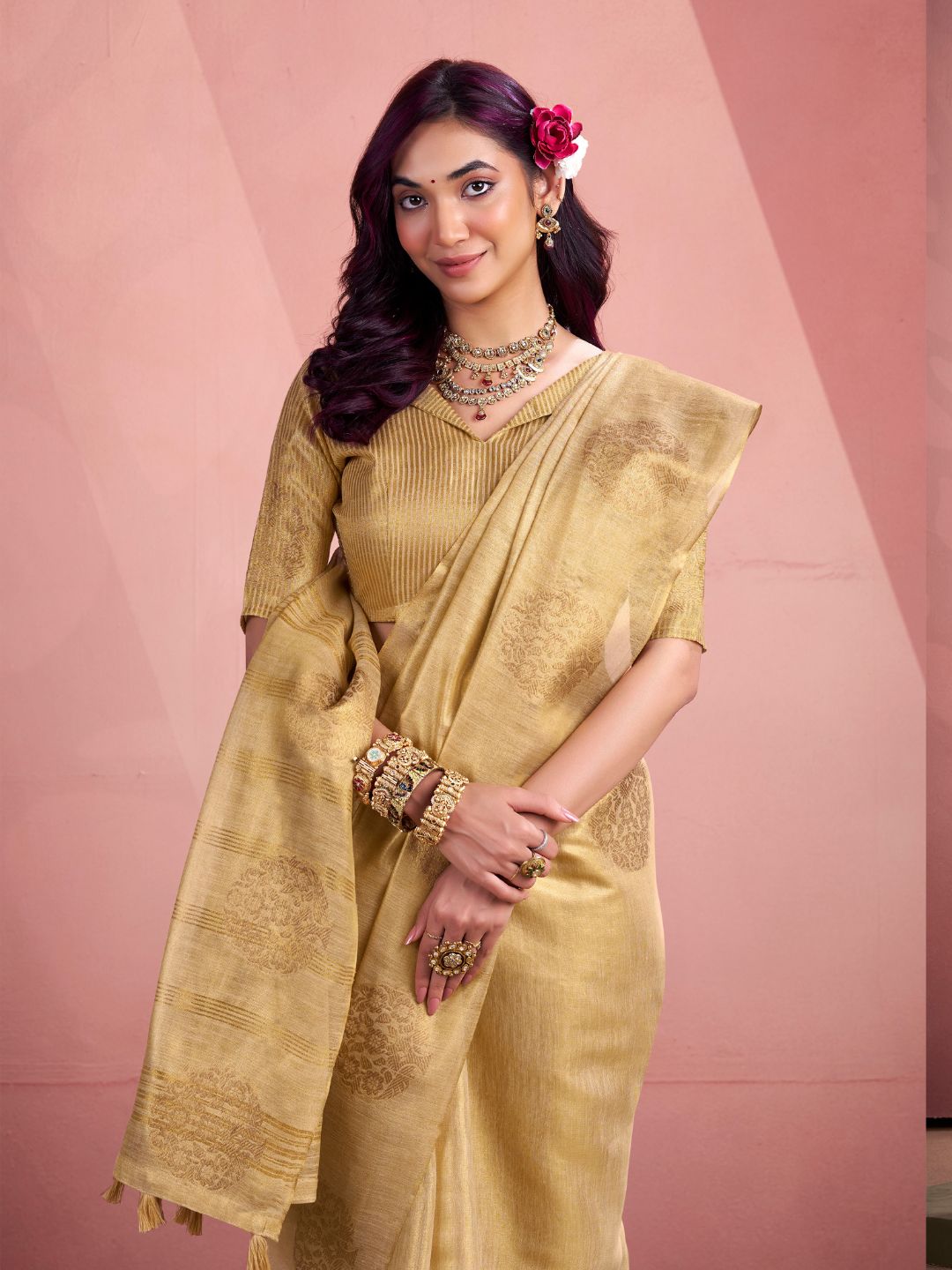 Close portrait of beige tissue silk saree with fancy zari weaving butta highlighting rich fabric texture