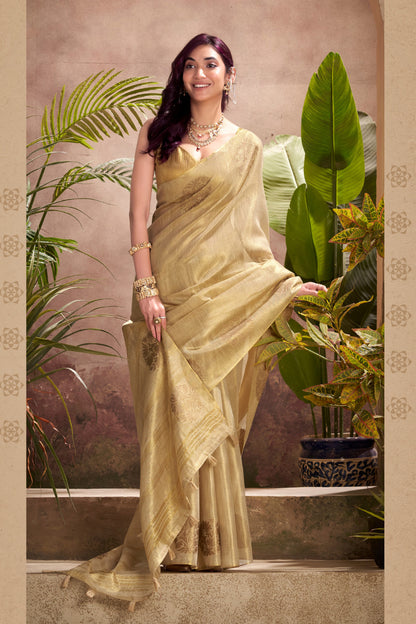 Model posing in beige tissue silk saree with zari butta and border pallu showing full length party and wedding styling