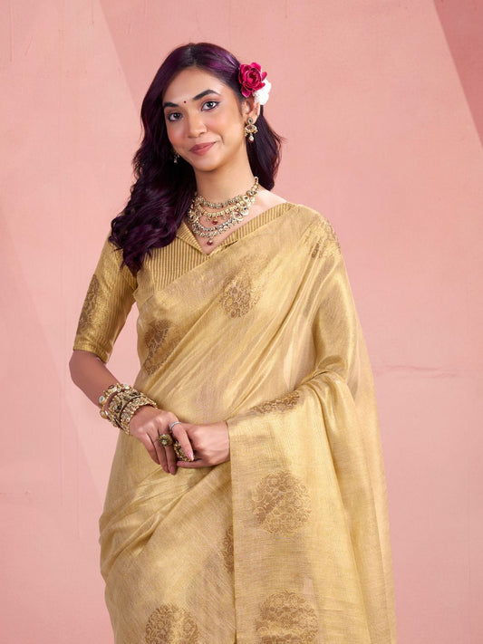 Close view of beige tissue silk saree with fancy zari butta showcasing elegant drape and detailing