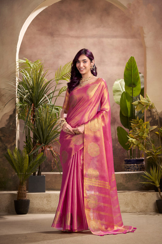 Woman wearing dark pink tissue silk saree with zari weaving butta and zari border pallu full front view