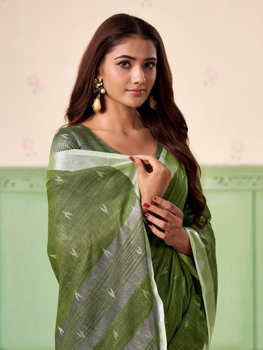 Close view of green linen silk saree showcasing thread woven butti design and elegant texture