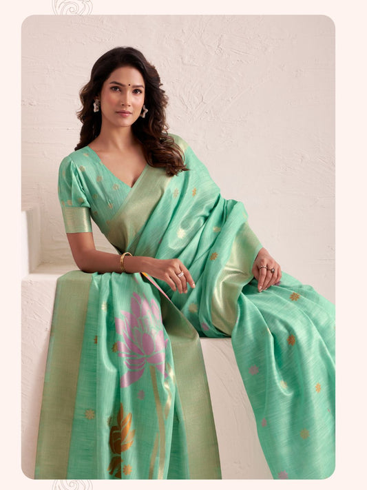 Model sitting in green linen silk saree with jacquard pallu showcasing elegant styling