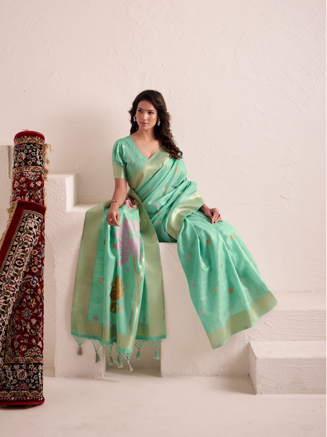 Model posing in green soft linen silk saree with jacquard weaving pallu showing full length elegant drape