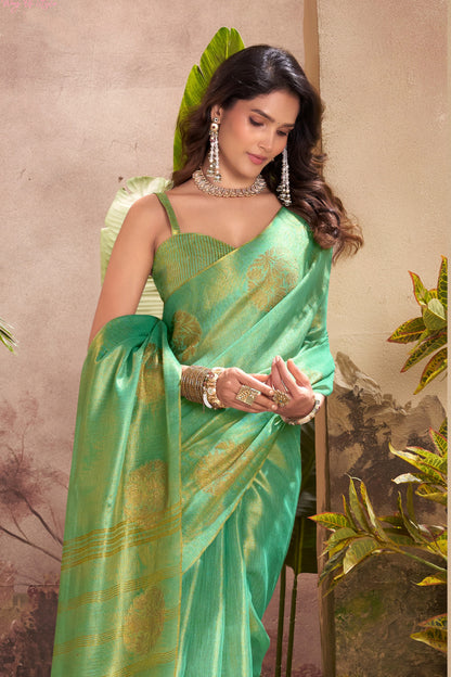 Close portrait of green tissue silk saree with zari weaving butta highlighting rich texture and graceful drape