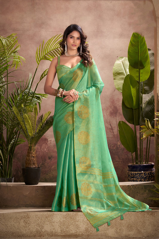 Woman wearing green tissue silk saree with zari weaving butta and zari border pallu full front view