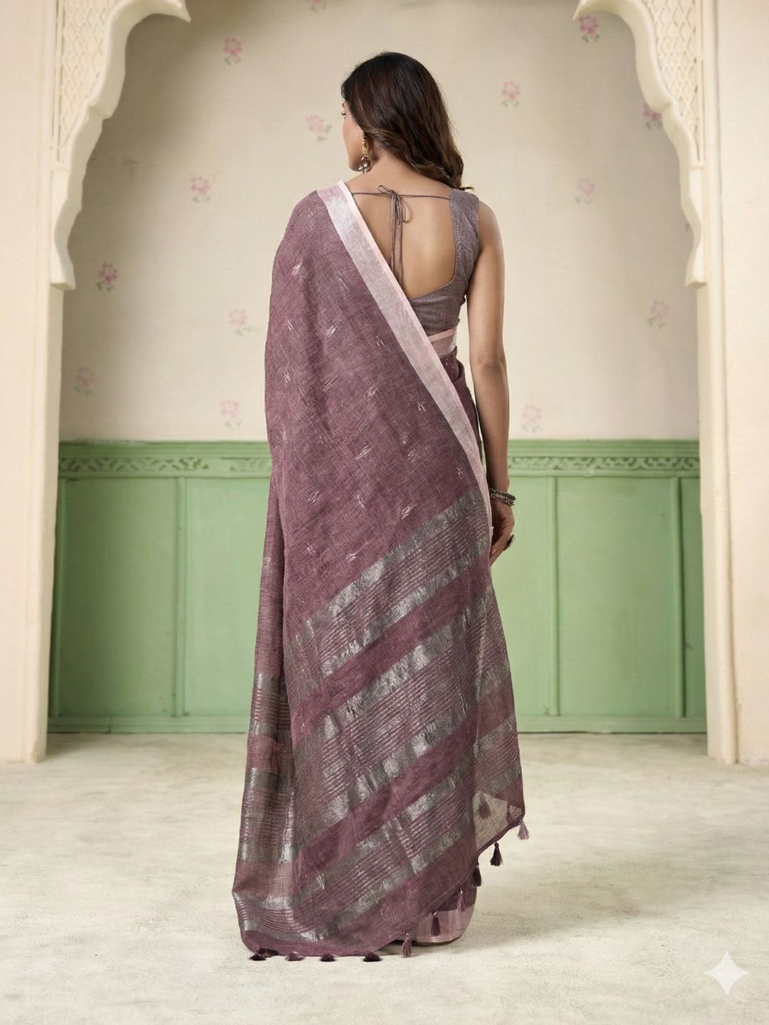 Back view of magenta linen silk saree with thread woven butti design highlighting graceful drape