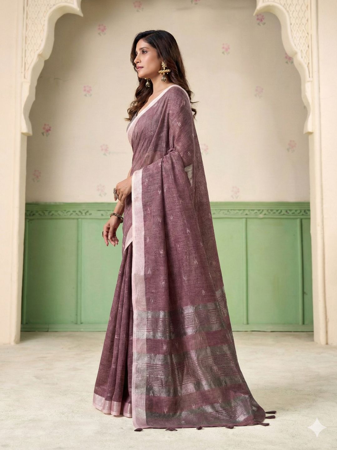 Model posing in magenta linen silk saree with woven butti design showing full length elegant styling