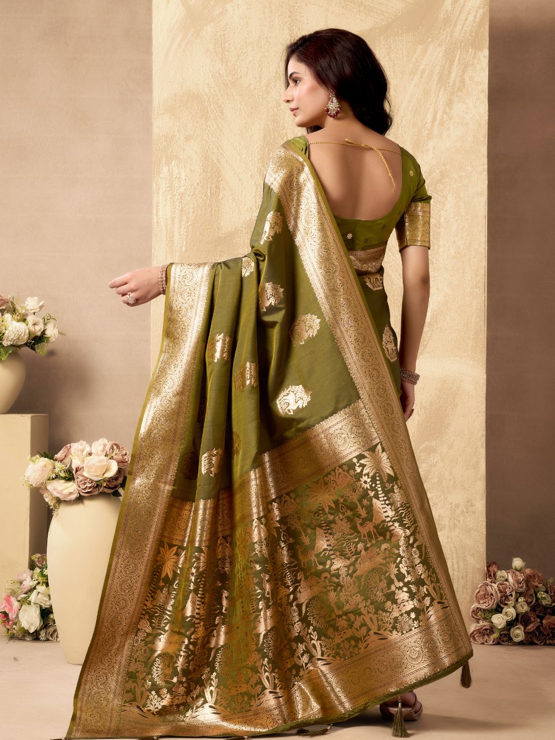 Back view of mehndi green Banarasi silk saree showcasing rich zari pallu and Warli weaving design