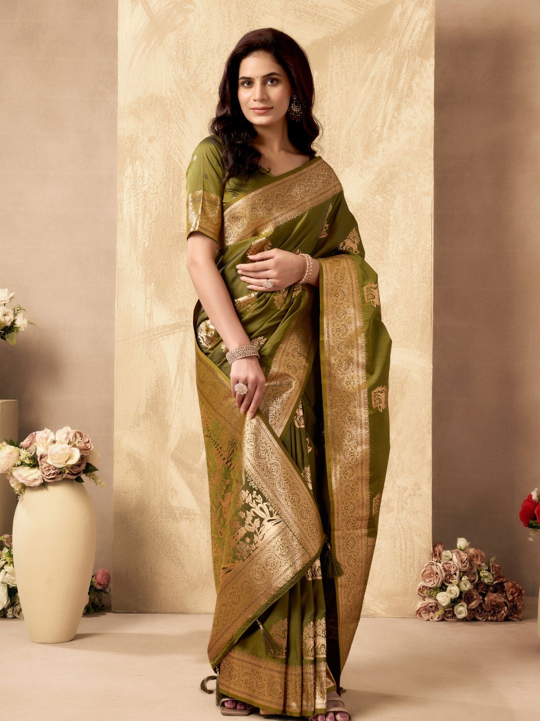 Model posing in mehndi green Banarasi silk saree with Warli work showing full length wedding styling