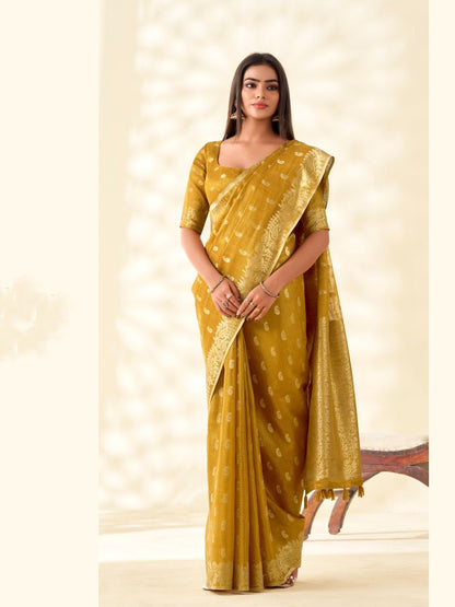 Model posing in mustard yellow tissue linen silk saree with zari butti and pallu showing full length elegant styling