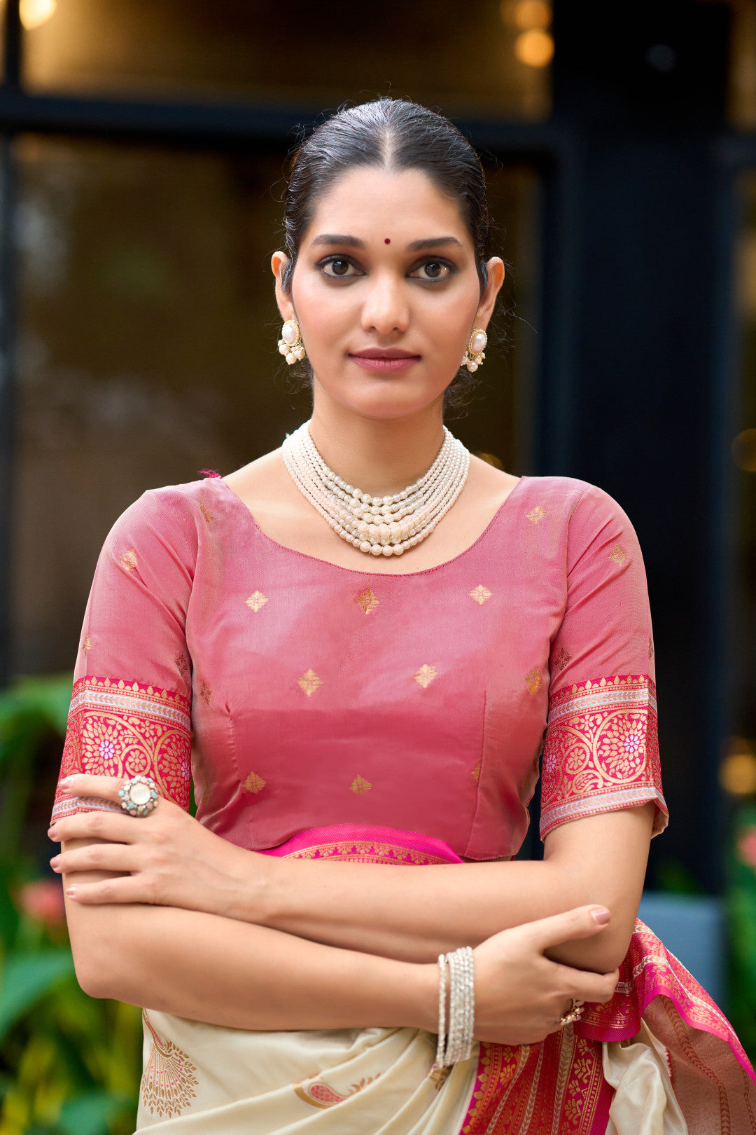 Closeup look of off white Banarasi silk saree blouse with zari weaving work