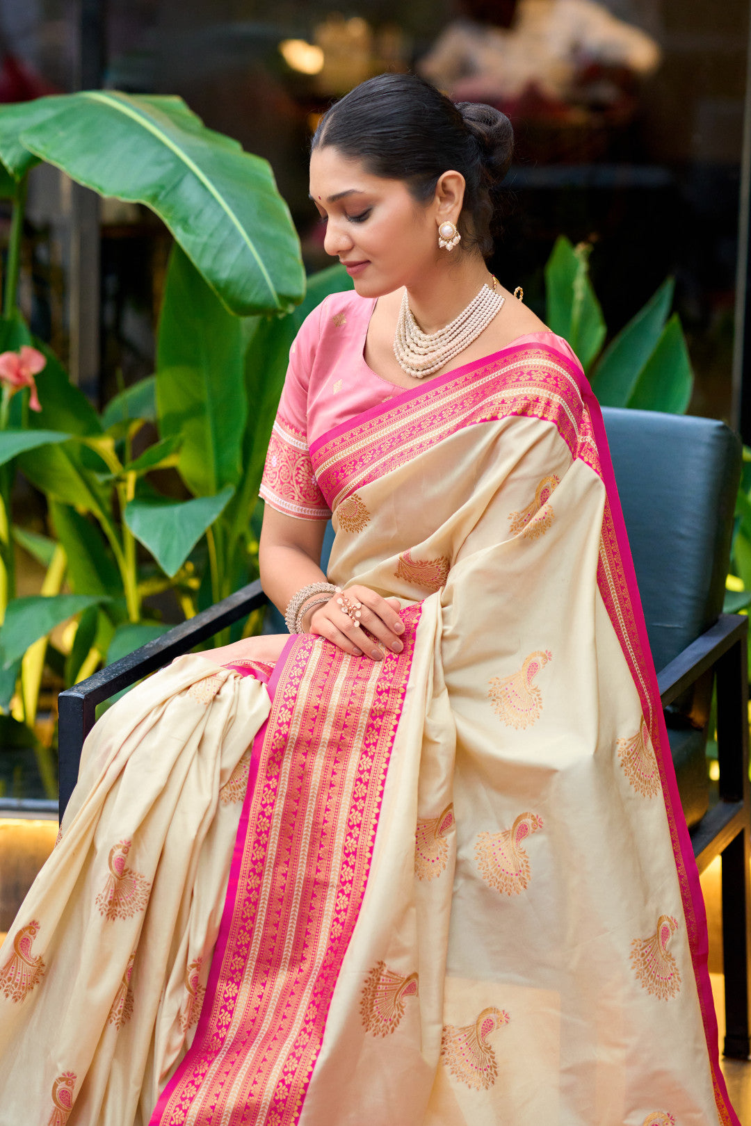 Model wearing off white Banarasi silk saree with zari weaving and contrast border