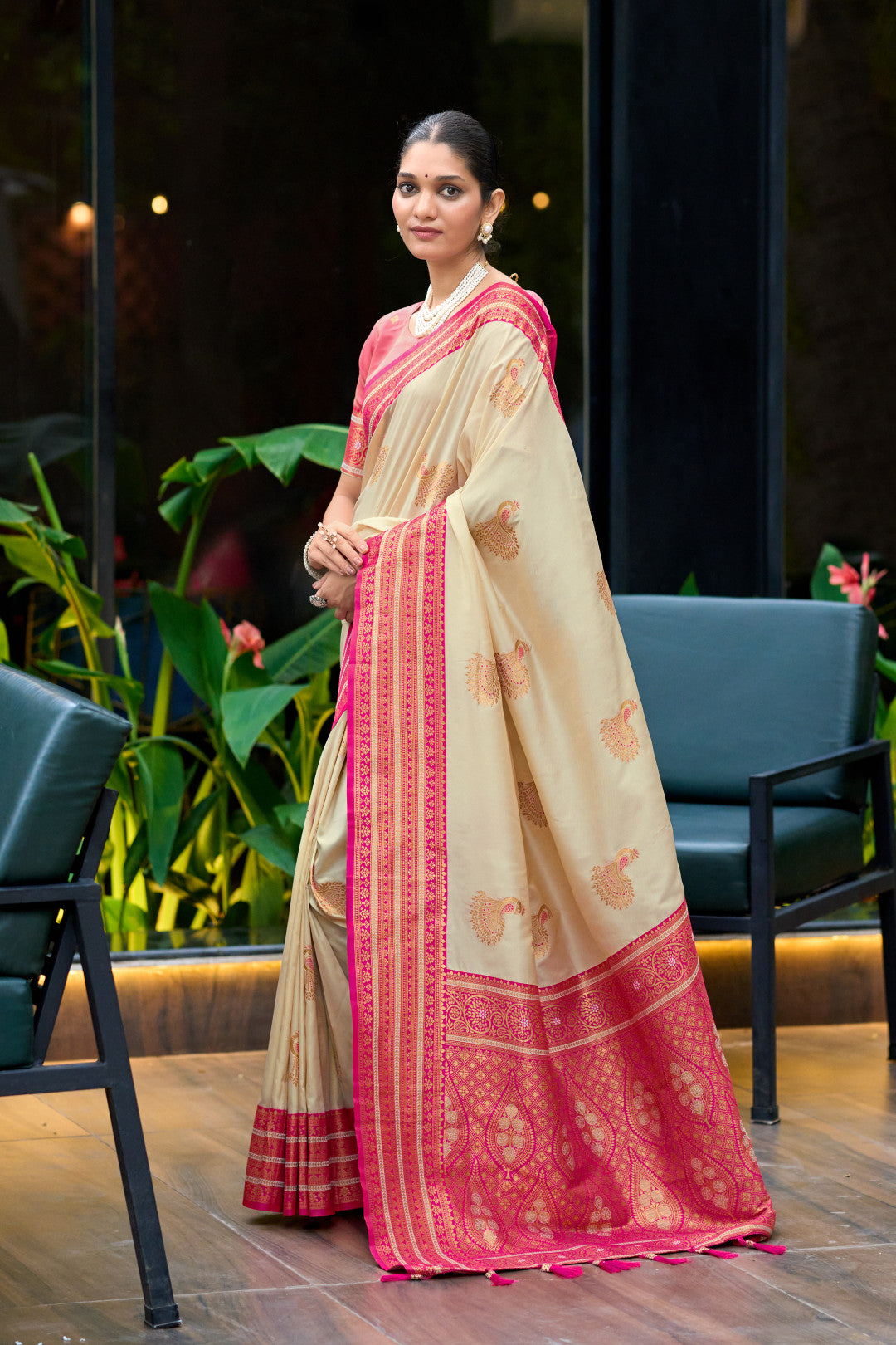 Off white Banarasi silk saree with contrast zari border in flowing drape look