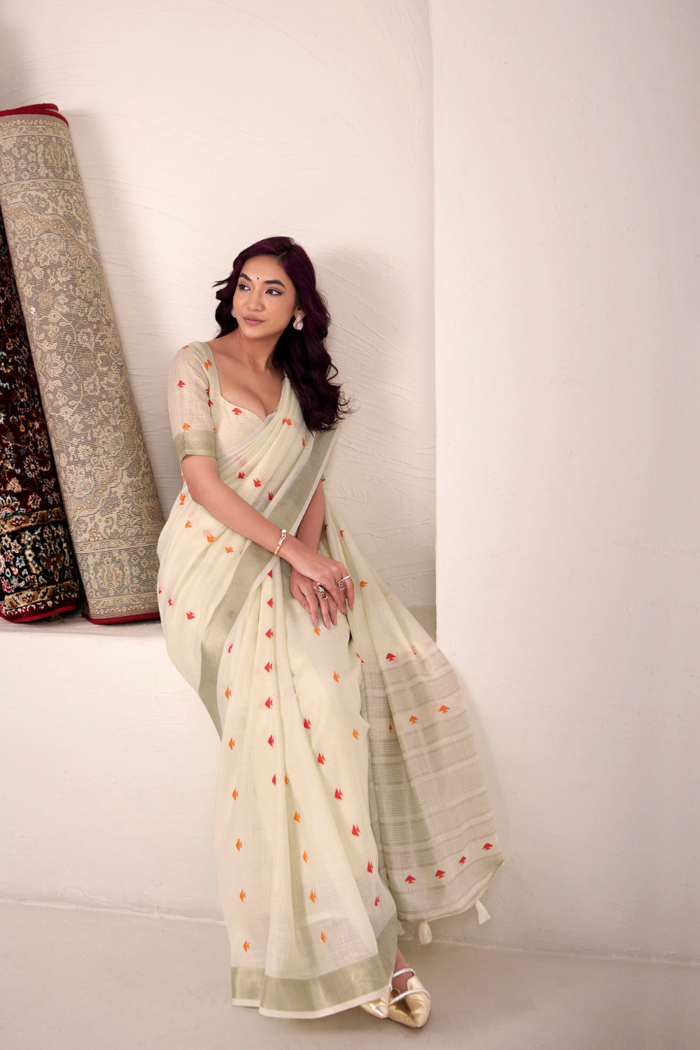 Off white linen silk saree with zari weaving showcasing side pose and graceful drape styling
