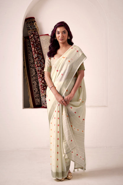 Woman wearing off white soft linen silk saree with zari weaving and elegant lining pallu full view