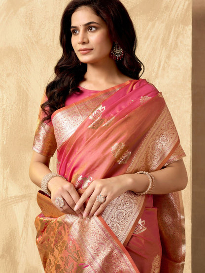 Portrait of model wearing peach Banarasi silk saree with zhallar border highlighting elegant drape