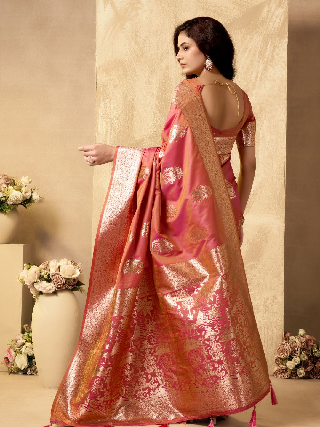 Side view of peach Banarasi silk saree with Warli weaving work showcasing graceful flow