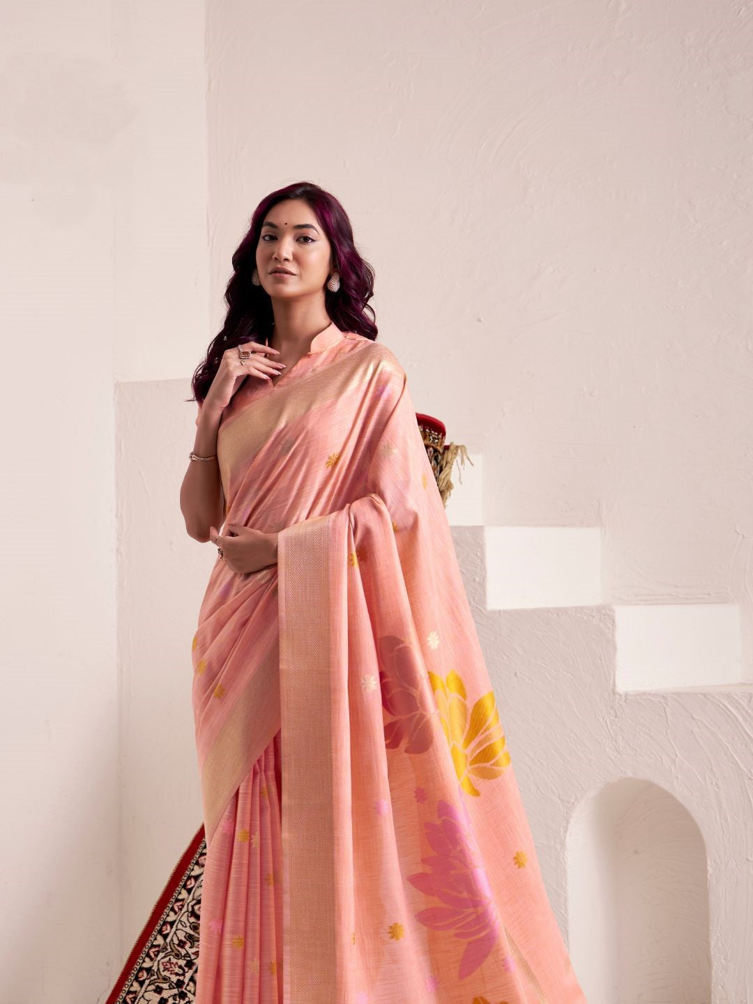 Side view of peach soft linen silk saree with floral pallu showcasing flowing drape