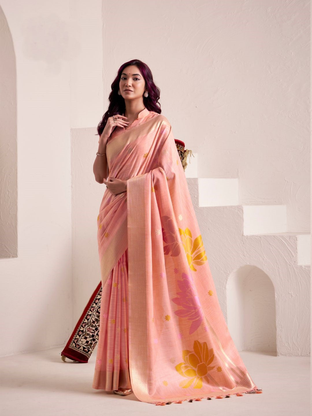 Woman wearing peach soft linen silk saree with floral pallu design full front view