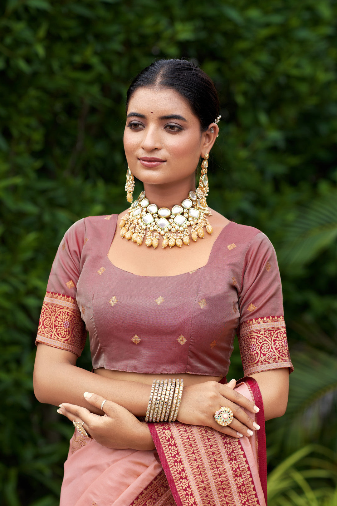 Woman wearing blouse of peach Banarasi silk saree with zari weaving