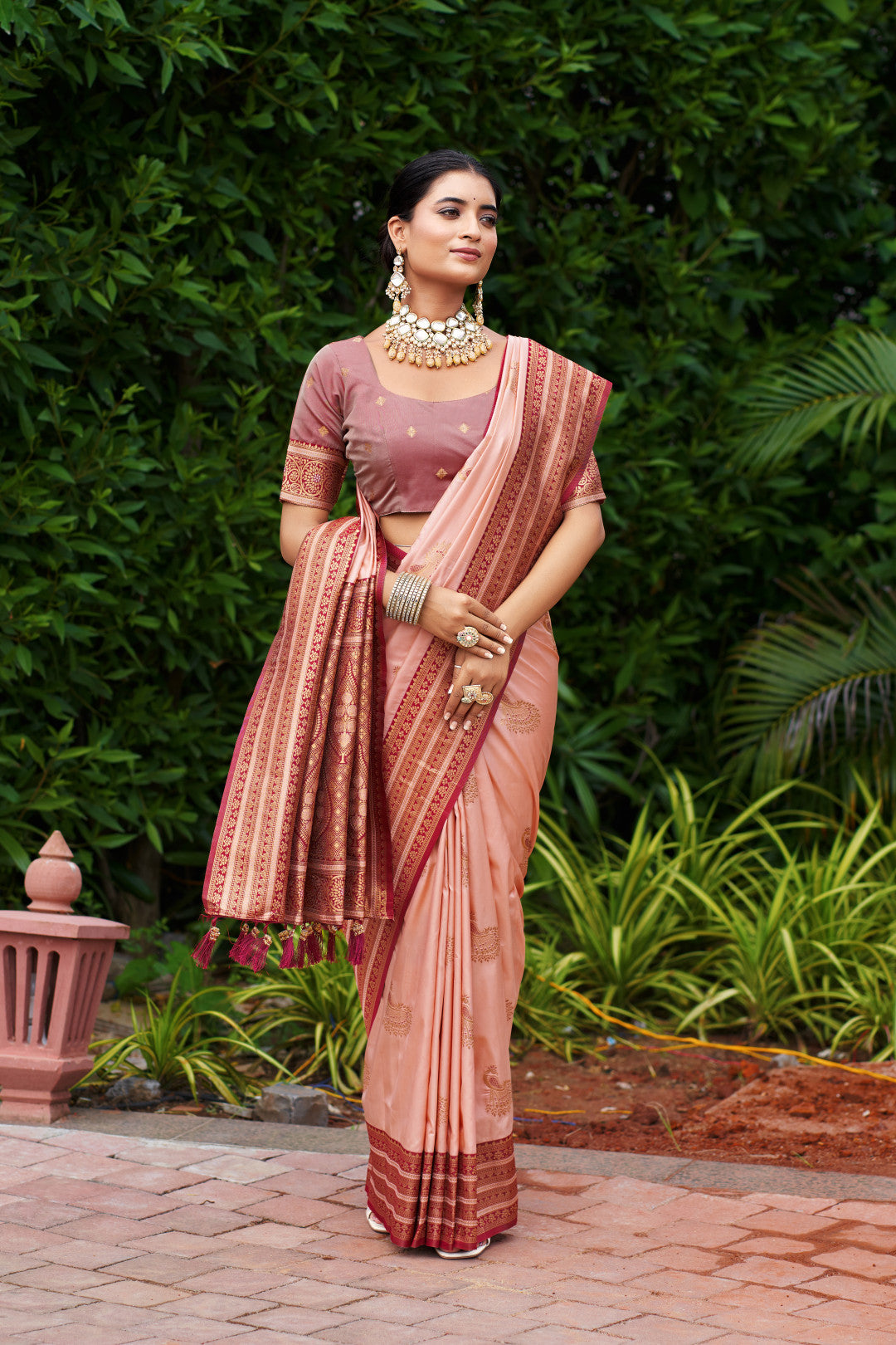 Woman wearing peach Banarasi silk saree with zari weaving