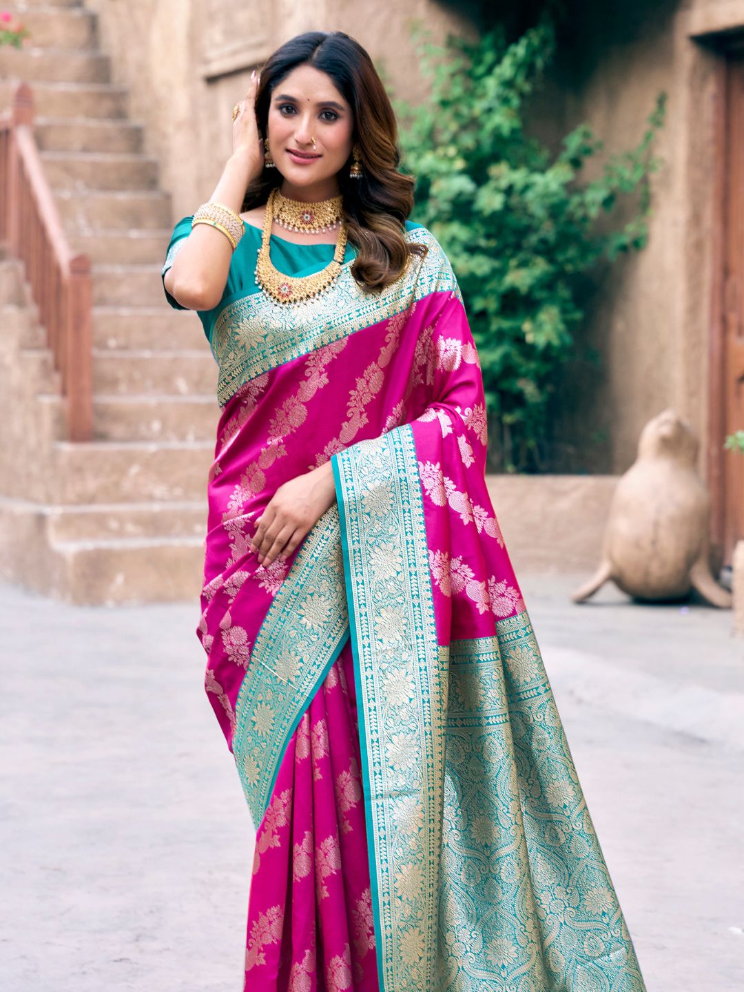 Side view of pink Banarasi silk saree with Warli weaving work showcasing graceful drape