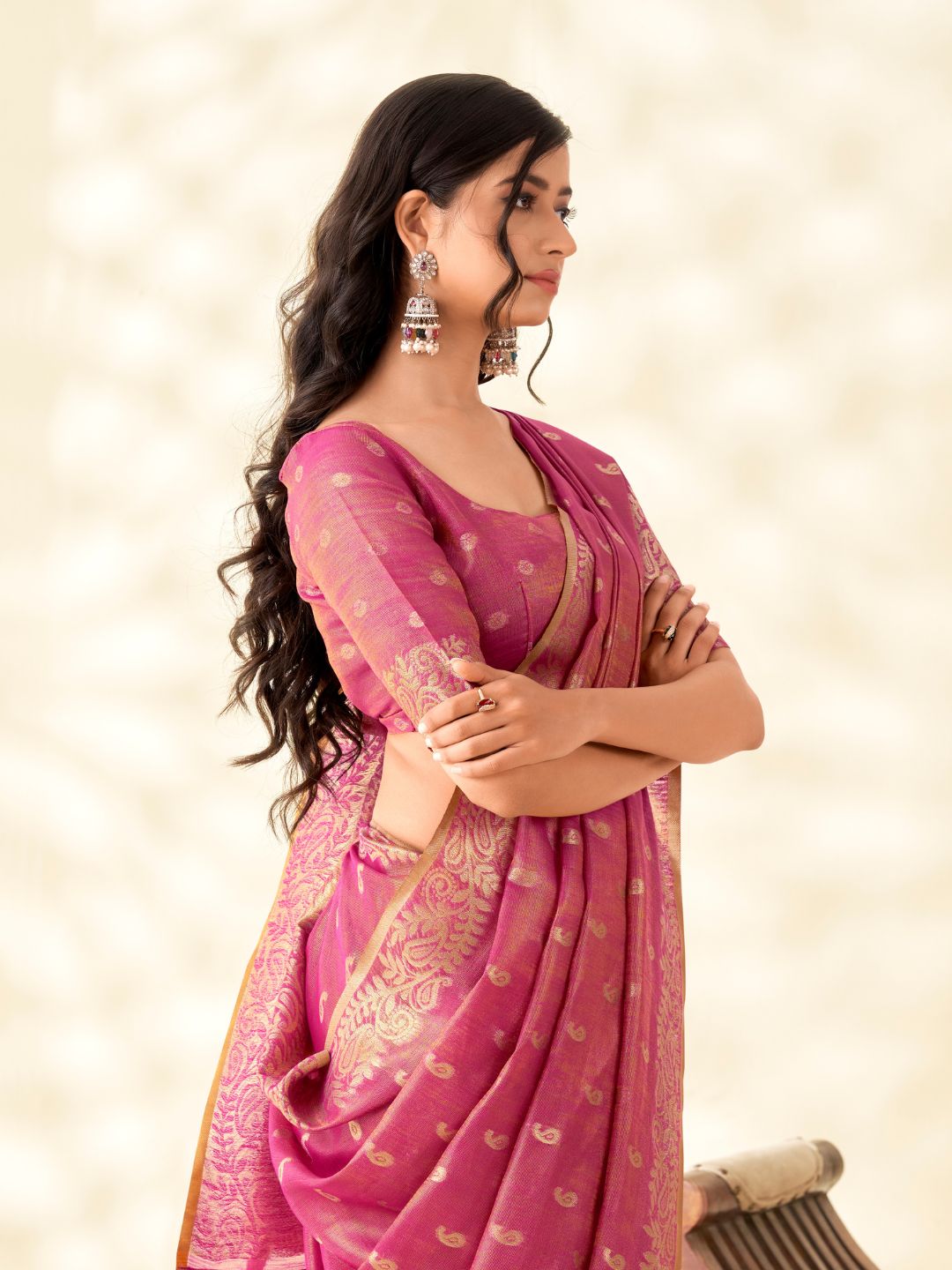 Side portrait of pink tissue linen silk saree with zari butti highlighting graceful drape