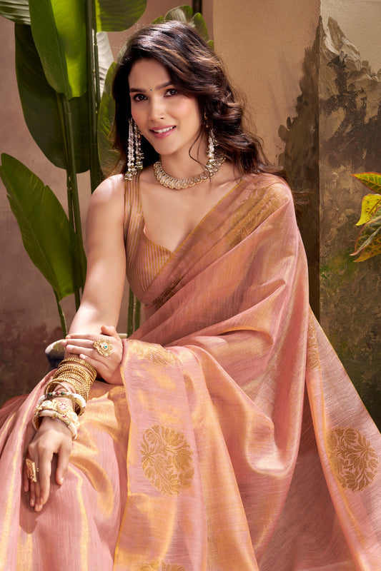 Close view of pink tissue silk saree showcasing zari weaving butta and elegant border detailing