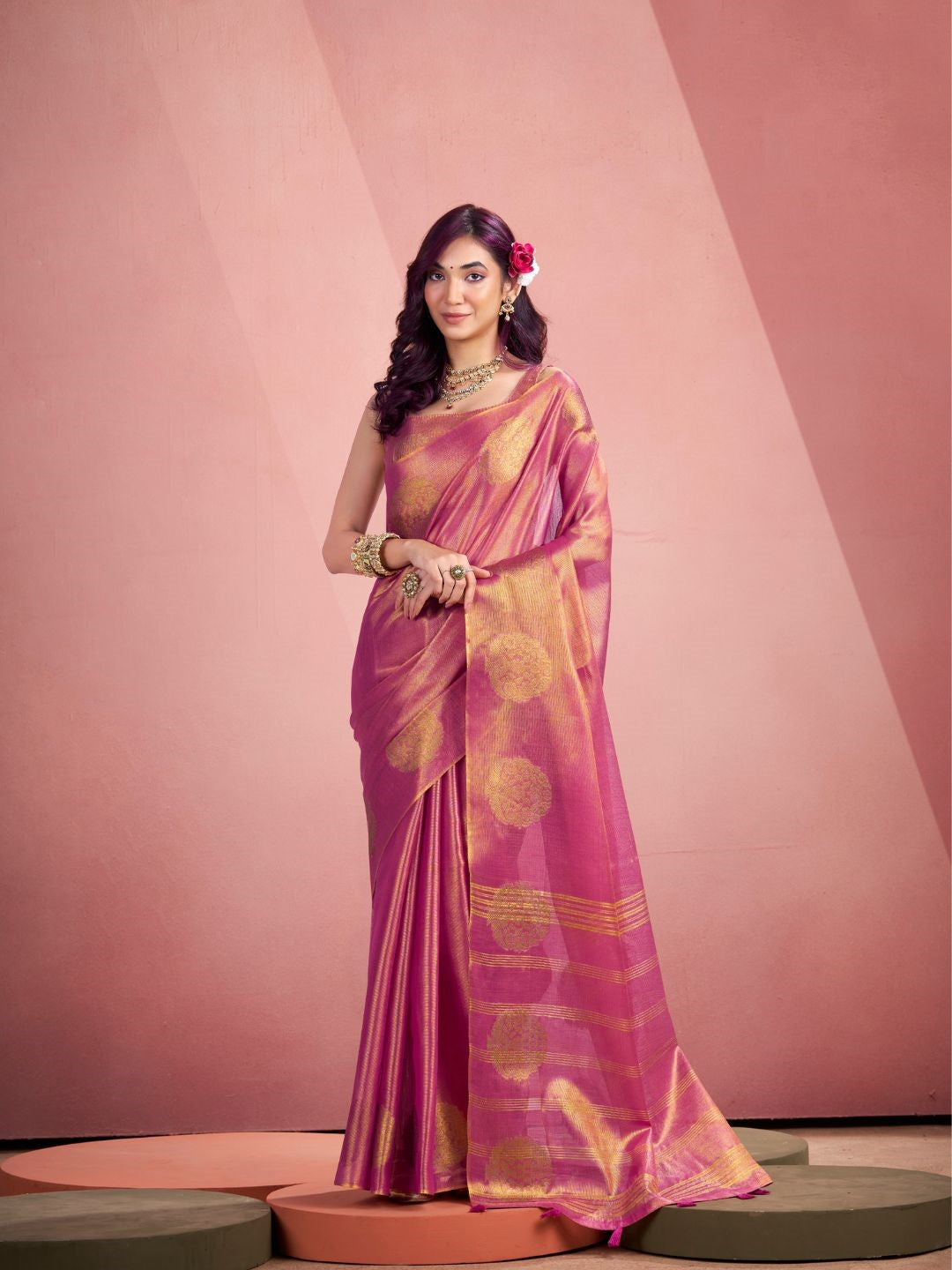Woman wearing pink tissue silk saree with fancy zari weaving butta full front view