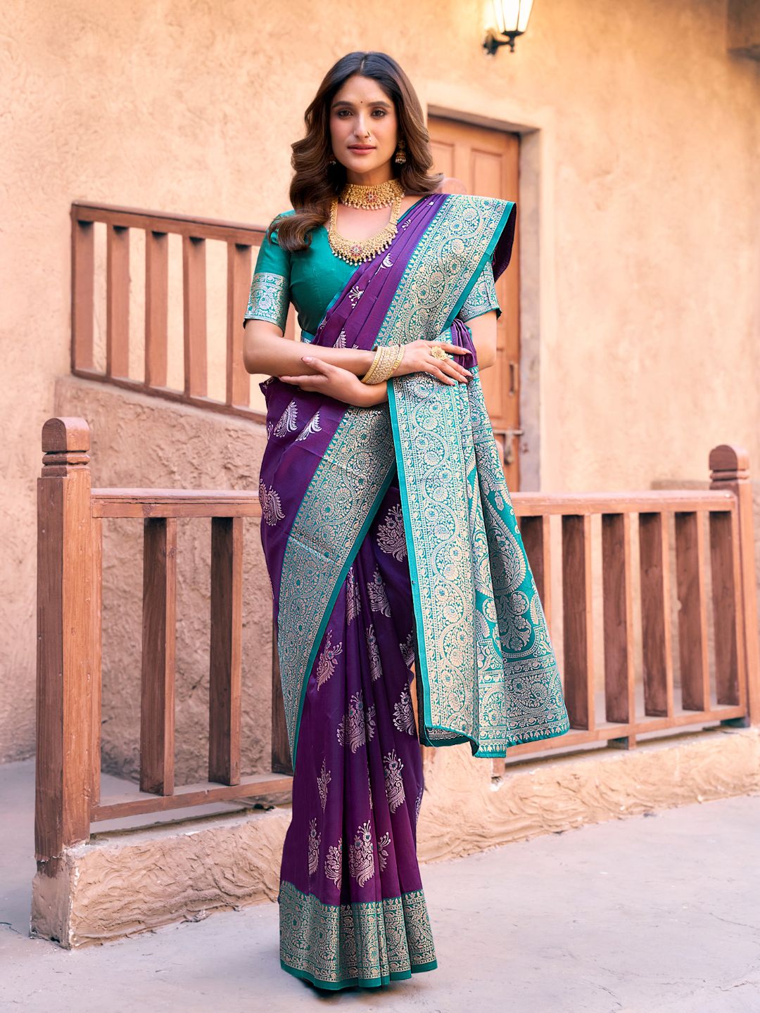 Model posing in purple Banarasi silk saree with Warli work showing full length wedding and festive styling