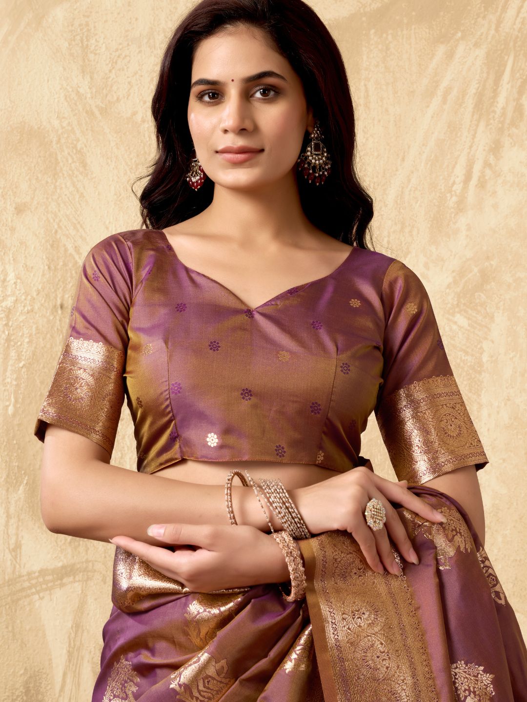 Portrait of model wearing purple Banarasi silk saree with zhallar border highlighting elegant drape