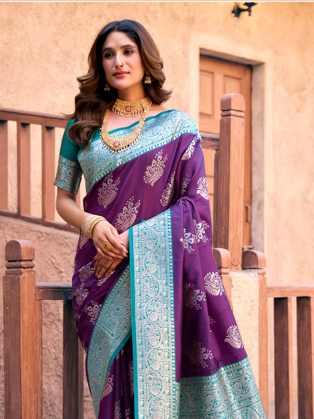 Side view of purple Banarasi silk saree with Warli weaving work showcasing graceful drape