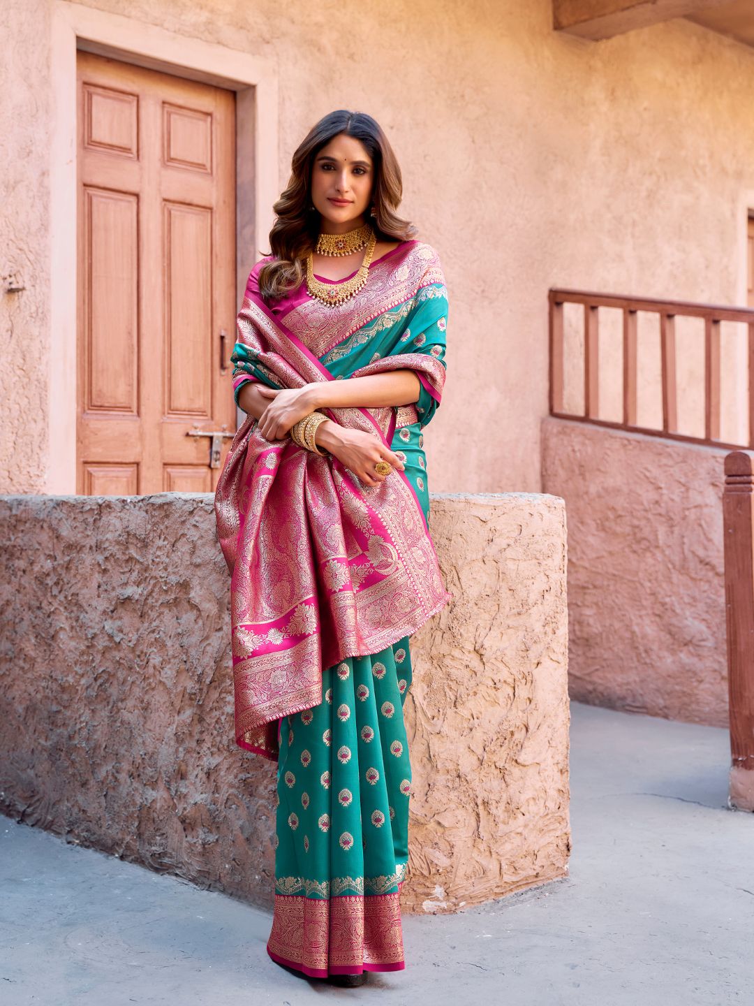 Model posing in rama green Banarasi silk saree with Warli work showing full length wedding and festive styling
