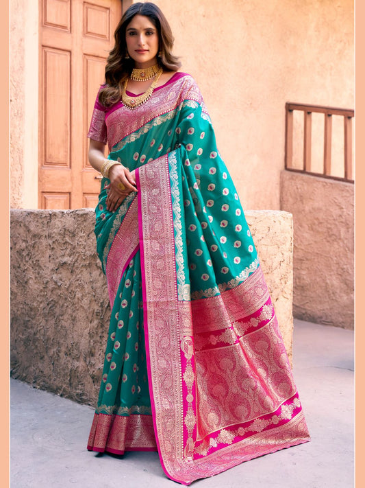 Woman wearing rama green Banarasi silk saree with Warli weaving work and zhallar border full front view