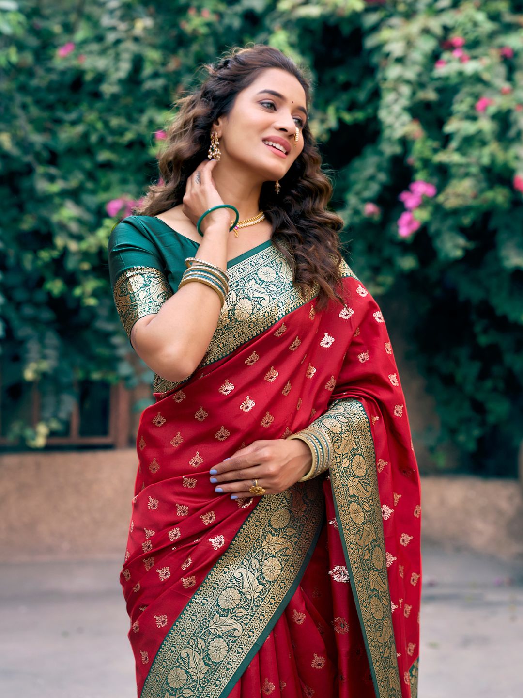 Model posing in red Banarasi silk saree with Warli work showing full length wedding and festive styling