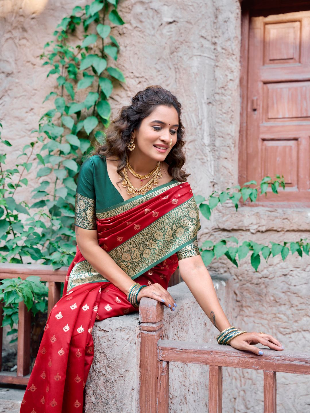 Side view of red Banarasi silk saree with Warli weaving work showcasing graceful drape
