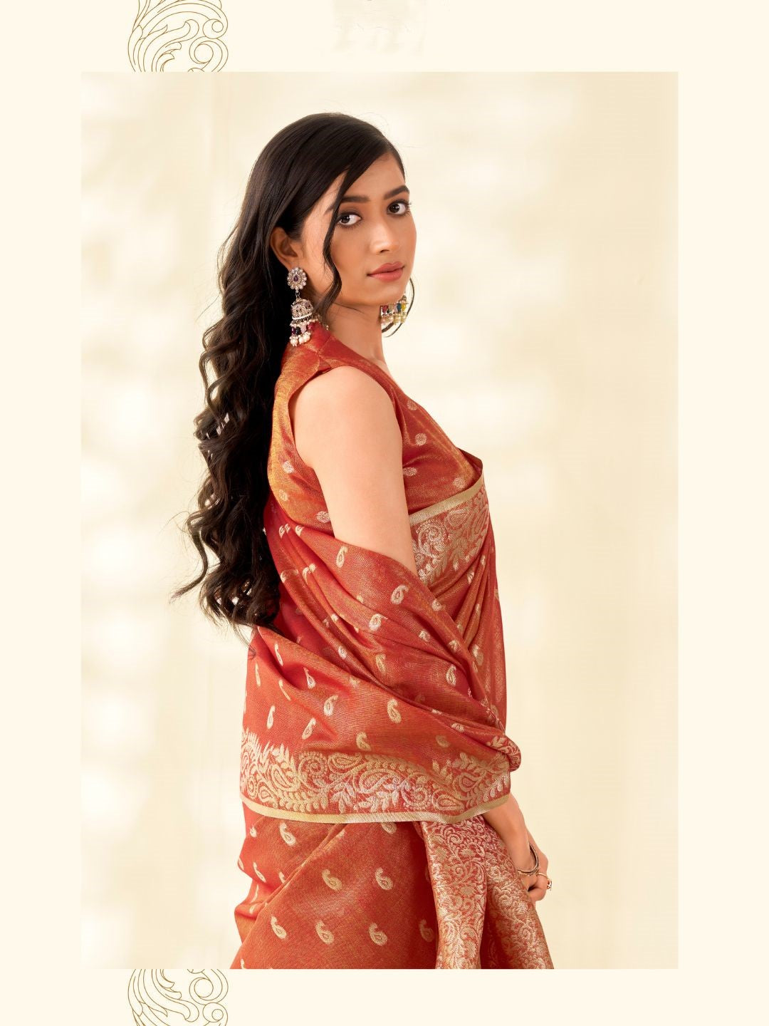 Side portrait of red tissue linen silk saree with zari butti highlighting graceful drape and rich texture